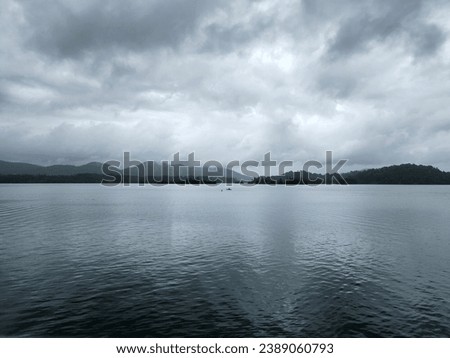 LAKE WHEN CLOUDY. The picture shows the calm state of the lake when the weather is cloudy and raining.