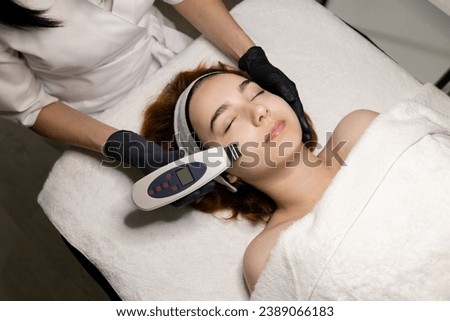 A young beautiful girl undergoes a hardware peeling procedure in a cosmetologist’s office. High quality photo