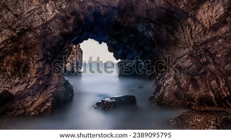 Long exposure of wave and rock of Jeonchon Yonggul Cave on the beach of Jeonchon-ri against horizon near Gampo-eup, Gyeongju-si, South Korea
