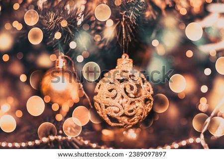 Close-Up Of Christmas Tree Decoration Indoors. Part of Christmas tree with Christmas decorations in a home interior