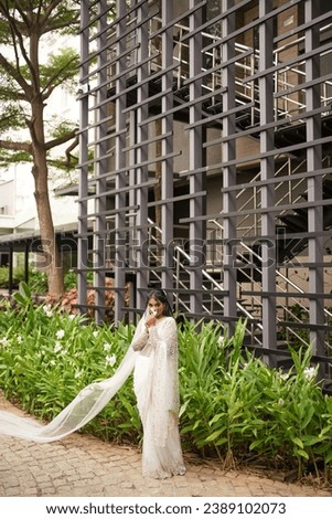 south Asian, wedding photography, woman, Christian wedding, outdoor, beautiful natural background , beautiful multiple different poses in a background of big open air building