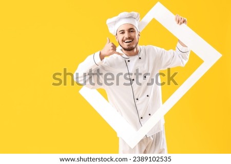 Male chef with frame showing "call me" gesture on yellow background