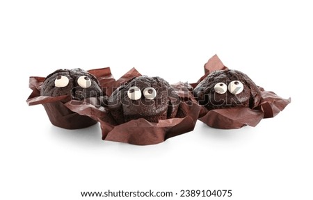 Delicious chocolate cupcakes in paper for Halloween celebration on white background