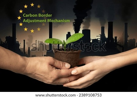 Hands of adult and child hold peat pot with green sprout of plant against backdrop of industrial cityscape with smoking chimneys and dark sky. CBAM. EU Carbon Border Adjustment Mechanism. Ecology