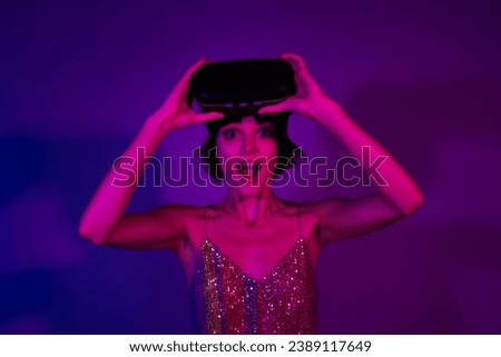 Photo of crazy shocked girl wear vr box goggles enjoy high tech simulation game on prom party isolated neon color background