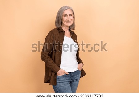 Portrait of toothy beaming stunning person with bob hairdo wear stylish jacket hold arms in pockets isolated on beige color background