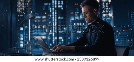 Close Up Portrait of Caucasian Businessman in a Suit Standing Next to Window in Big City Office with Skyscrapers Late At Night. Male General Manager Looking Out Of Window Thoughtfully.