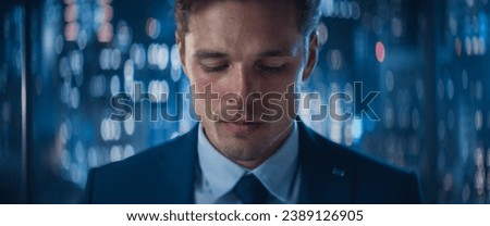 Close Up Portrait of Handsome Caucasian Businessman in Stylish Suit Posing Next to Window in Big City Office with Skyscrapers Late At Night. Male CEO Smiling And Looking At Camera.