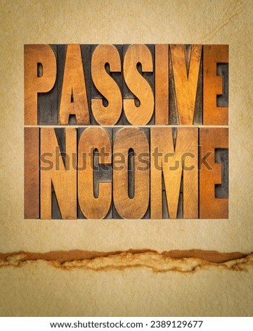passive income - word abstract in letterpress wood type on art paper, business financial concept