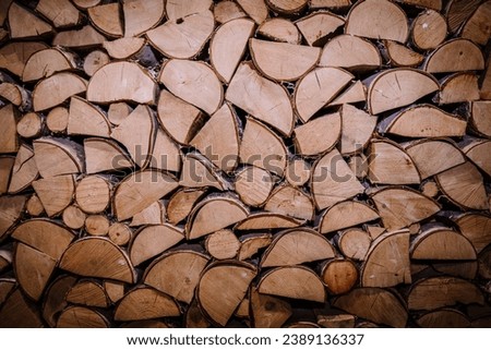 Prepared firewood. Natural wooden texture, background. Nature, environment, ecological damage, deforestation and reforestation, alternative energy and fuel, heating, lumber industry themes