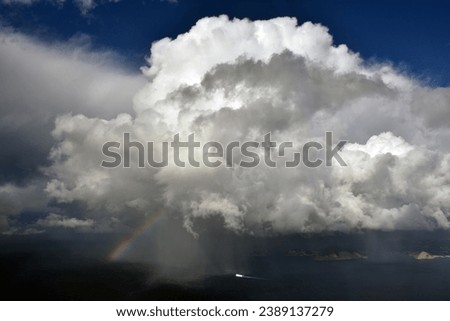 Storm cloud, rainbow and boat, located in Mallorca, Balearic Islands, Spain. Royalty-Free Stock Photo #2389137279
