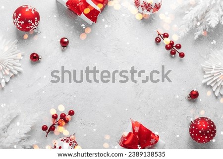Merry Christmas and Happy Holidays greeting card, frame, banner. New Year. Noel. Red Christmas ornaments on white background top view. Winter holiday xmas theme. Flat lay. Royalty-Free Stock Photo #2389138535