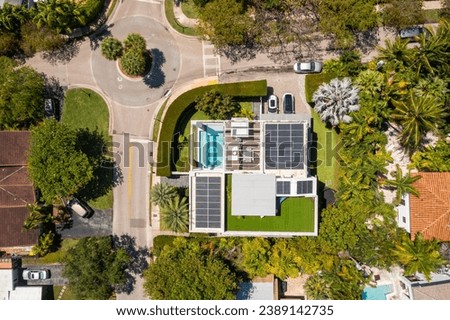 Aerial drone photoshoot Footage in Florida, USA, commercial area, luxury houses, buildings and mansions, abundant tropical vegetation around, blue skyline and swimming pools. 