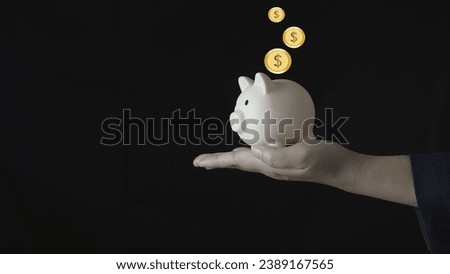 businessman putting coin on the piggybank and icon family on table, donation, saving, charity, family finance plan concept, fundraising, superannuation, investment, financial crisis concept.