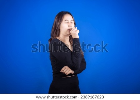 Beautiful mature Asian woman suffering from sore throat and cough.