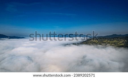 Fog over the mountains with a view of the mountain peaks. View of the mountains from aerial photography. Beskid Sądecki and the Tatra Mountains