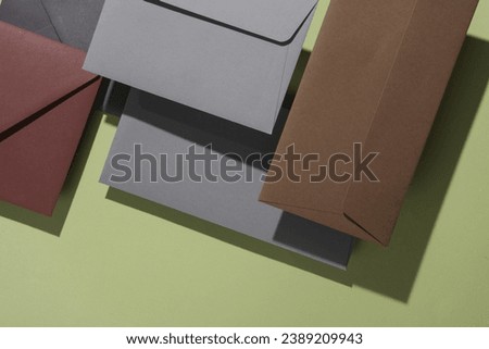 Floating envelopes with card on green background with shadow. Minimalism, modern business still life