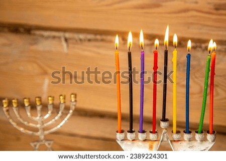 Hanukkah candles are lit in the Hanukkiah next to the menorah. Horizontal photo