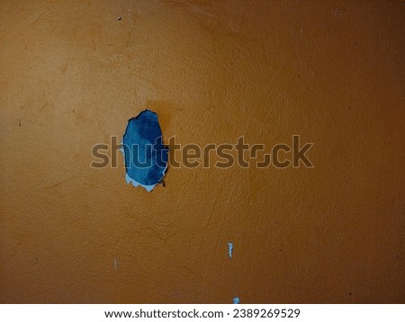 close-up of peeling paint on orange wall