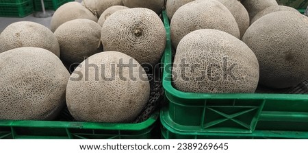 Pile of melons in a marketplace basket, honeydew in basket at market place