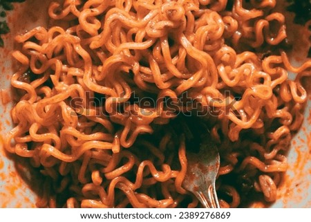 a brown fried instant noodle on a plate