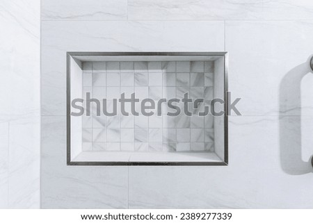 A minimalist shower niche with white marble tiles provides a sleek and practical storage solution in a modern bathroom setting Royalty-Free Stock Photo #2389277339