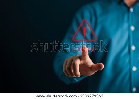 Security concept. Businessman touching the visual alert symbol.