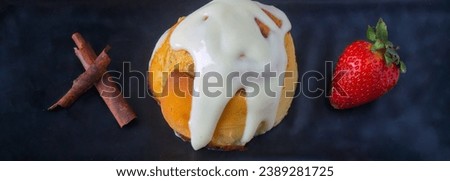 Detail of a piece of delicious cinnamon rolls with cream topping.