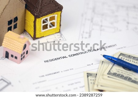 Residential construction agreement ready to sign with small toy houses and pen. Construction contract. Permission to build