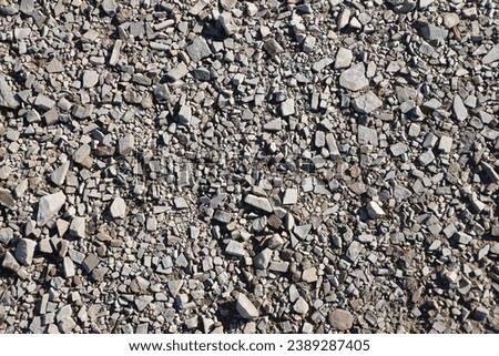 Background of shattered stony stones surface in mountain area. Flat texture with natural light
