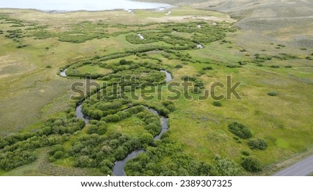 Aerial View of Serene Countryside Wetland with Green Fields and Peaceful Scenic View
