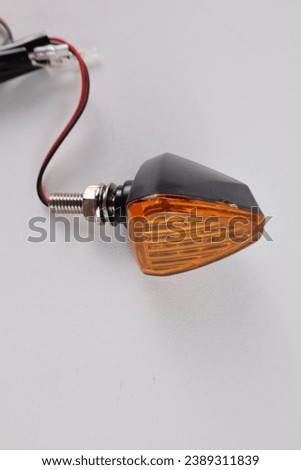 Flashing turn signals, with orange colored glass motorcycle lights isolated on white background