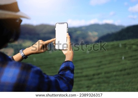 Tourist using a white empty screen mobile phone