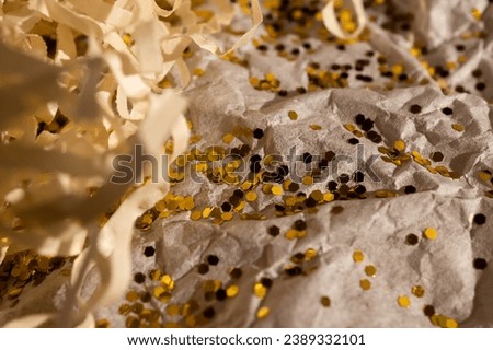 Background made from box filler and glitter. Gift packaging. Festive background Royalty-Free Stock Photo #2389332101