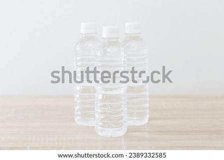 A plastic bottle of drinking water on the desk.
