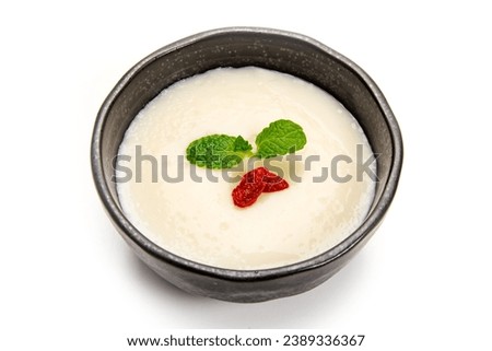 Almond tofu, mint and goji berries on a white background