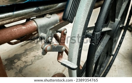 The manual brake on the wheelchair has started to rust Royalty-Free Stock Photo #2389354765