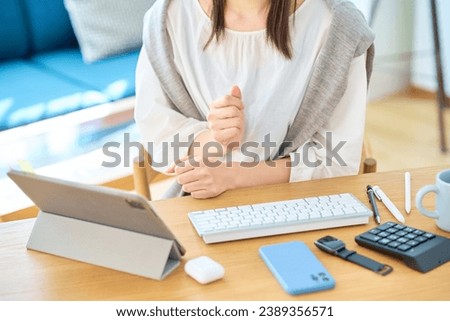 Hands of a woman communicating online
