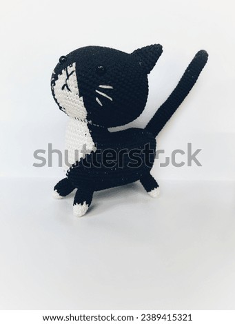Black cat doll mixed with white on a white background