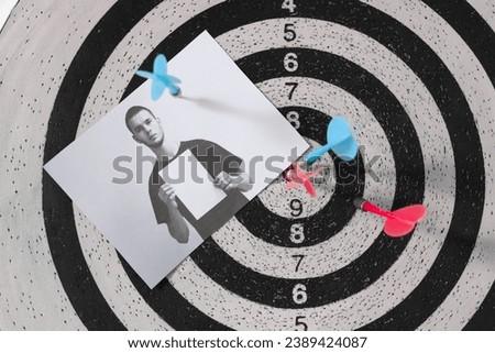 Dartboard with picture of criminal and bullseye in FBI office, closeup