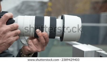Man taking picture by professional camera in outdoor.