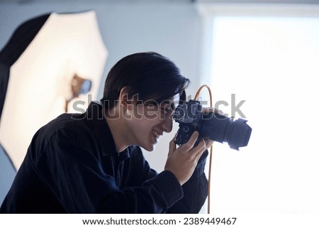 Japanese photographer taking pictures in a photo studio