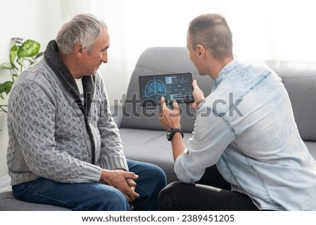 Picture of European doctor talking with elderly male patient and sitting in the studio, isolated on white background
