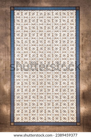 Retro flower pattern of tiles, surrounded by concrete flooring