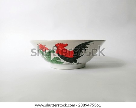 Bowls with pictures of roosters like this seem to be commonplace everywhere, and are typical for serving chicken noodles Royalty-Free Stock Photo #2389475361