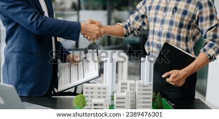 balancing the property sector The real estate agent is explaining the house style to see the house design and the purchase agreement. house at office