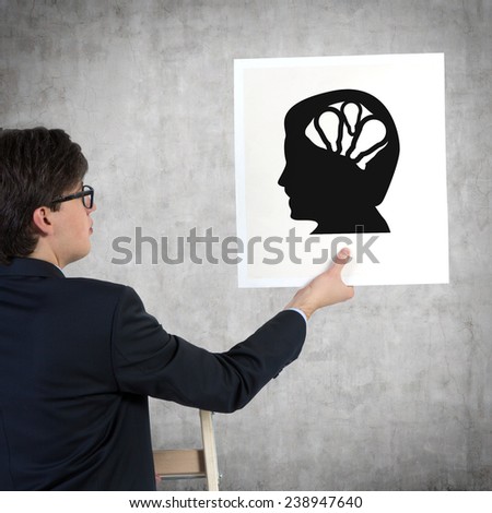 businessman holding paper with silhouette of the head