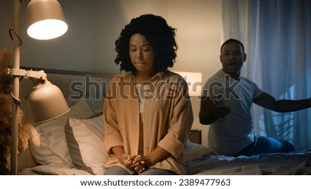Couple quarrel sad African American woman feel desperate jealous husband angry man shouting accusing screaming yelling talking to wife breakup marriage divorce in bed night problem unwanted pregnancy
