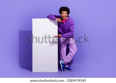 Full size photo of ecstatic guy dressed stylish pullover violet pants demonstrate smartphone display isolated on purple color background