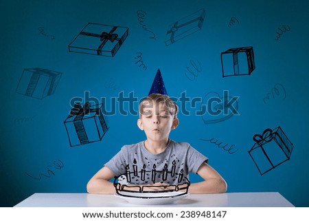 Little boy blowing the candles on his birthday cake